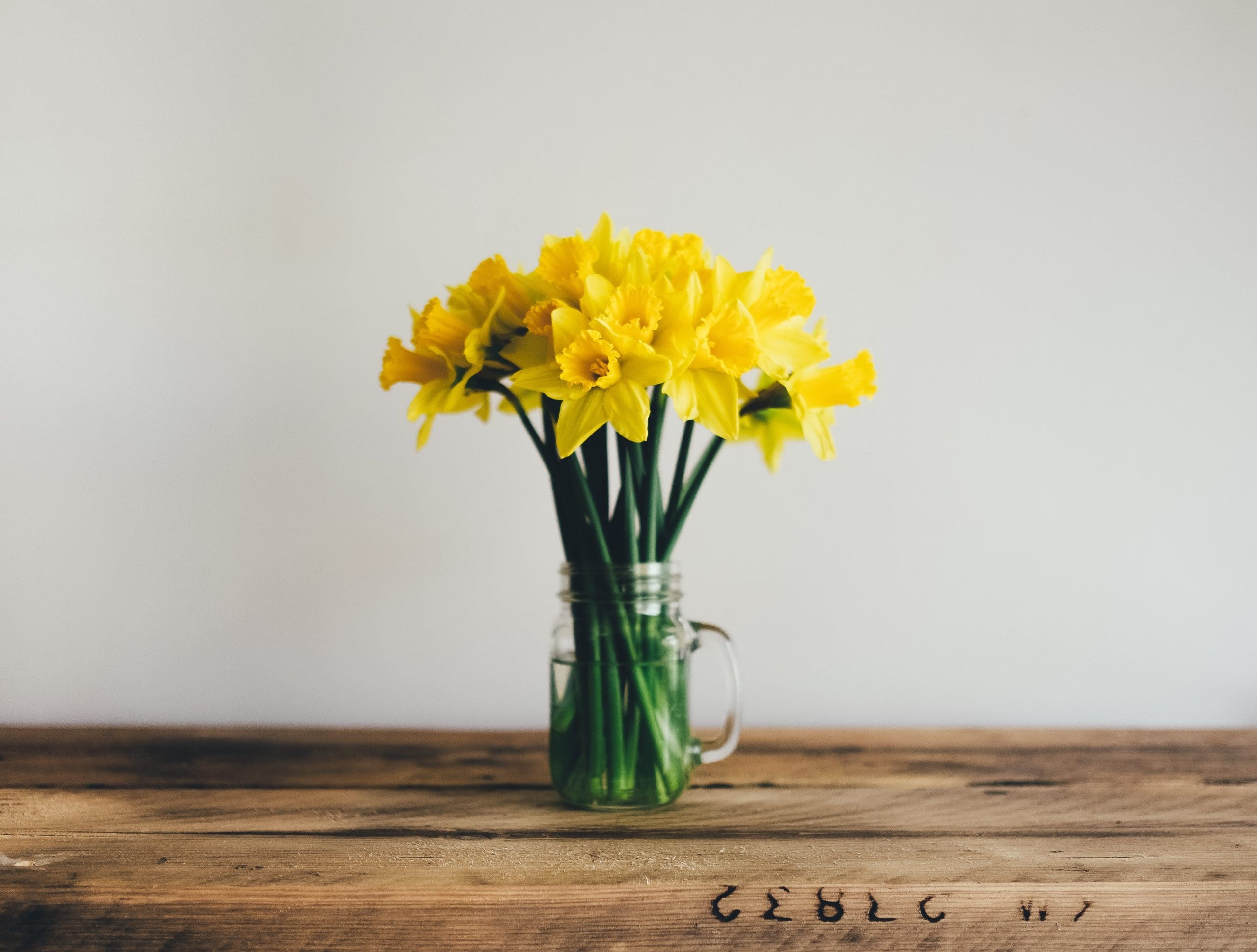 yellow petal flowers in clear glass vase