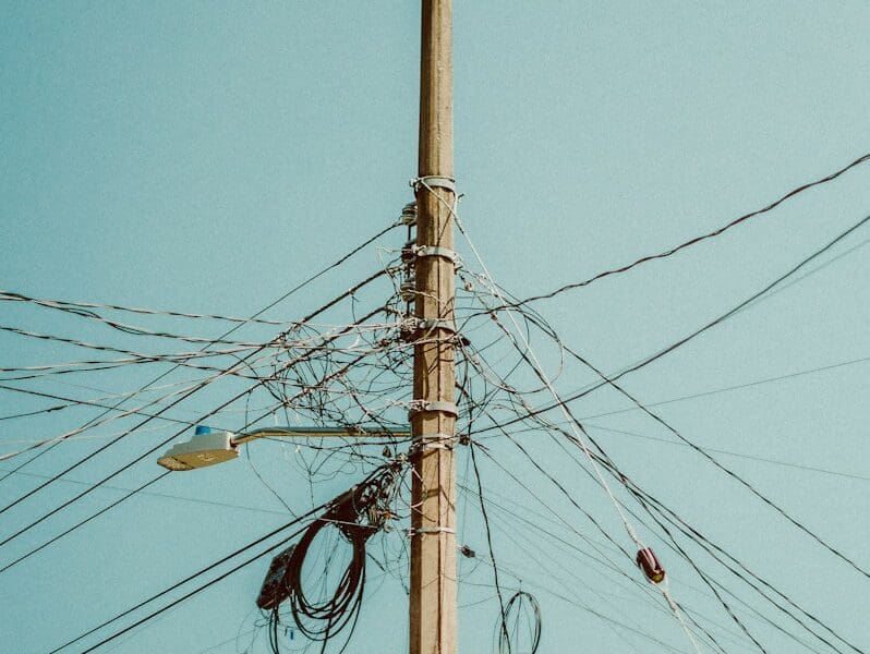 a telephone pole with a bunch of wires attached to it